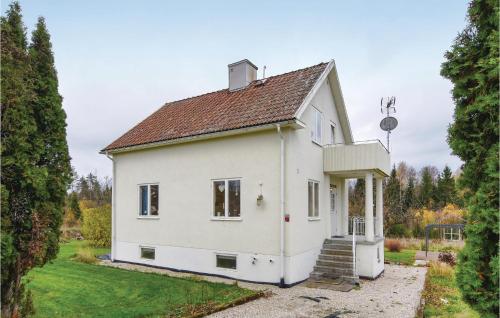 a white house with a brown roof at Cozy Home In Åsensbruk With Kitchen in Åsensbruk