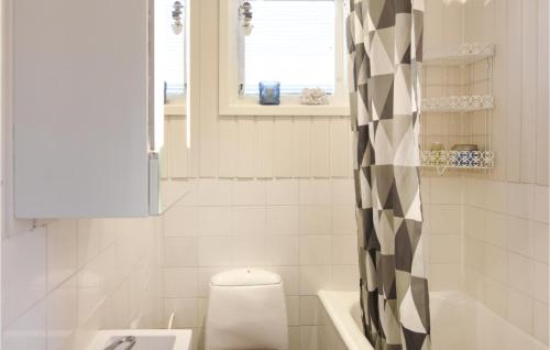 a bathroom with a toilet and a sink at Cozy Home In sensbruk With Kitchen in Åsensbruk