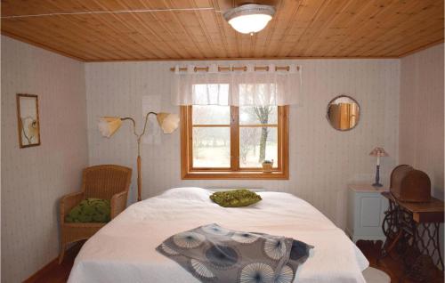 a bedroom with a bed and a window at Awesome Home In Skillingaryd With 3 Bedrooms And Sauna in Södra Nässja