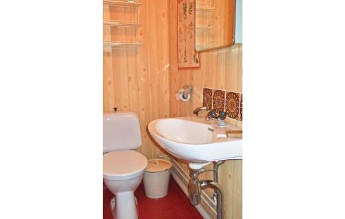 a bathroom with a toilet and a sink at Cozy Home In Tcksfors With Kitchen in Navarsviken
