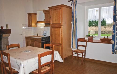 a kitchen with a table and a dining room at Amazing Home In Kerbors With 2 Bedrooms in Kerbors