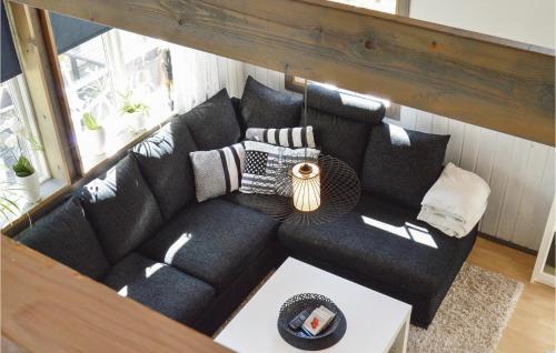 a black couch in a living room with a table at Lovely Home In Strängnäs With Kitchen in Strängnäs