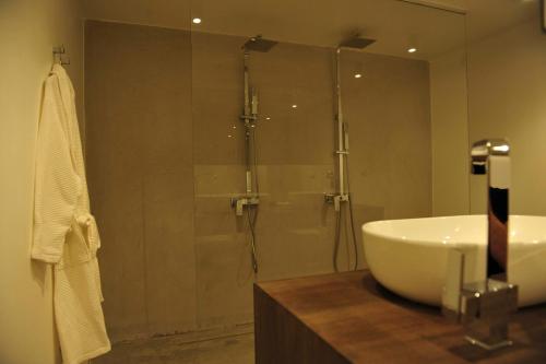 a bathroom with a shower and a white sink at Villa Panorama - Szklany Dom in Jaworzynka