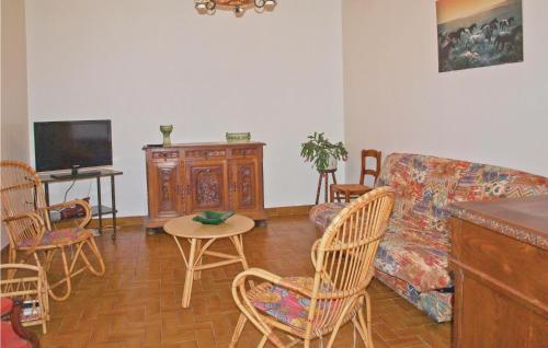 a living room with a couch and chairs and a table at Holiday Home Kerbors Wx-1650 in Kerbors