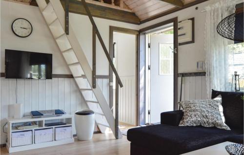 a living room with a staircase and a couch at Lovely Home In Strängnäs With Kitchen in Strängnäs