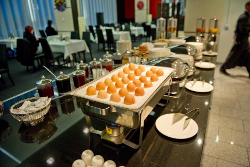 a buffet with a tray of eggs on a table at Pannonia Tower in Parndorf