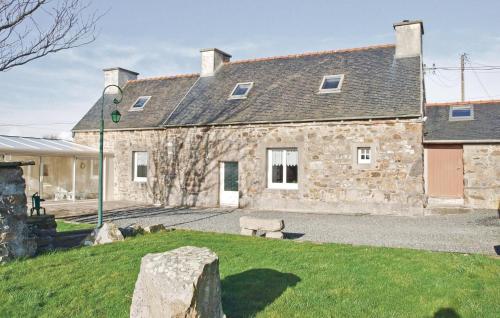 a stone house with a bench in front of it at Holiday Home Kerbors Wx-1650 in Kerbors
