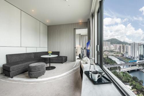 a living room with a couch and a table at ALVA HOTEL BY ROYAL in Hong Kong