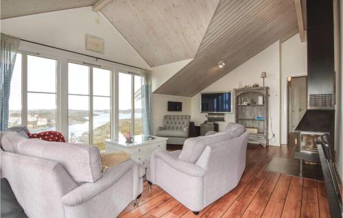 a living room with two chairs and a fireplace at Beautiful Home In Kyrkesund With Sauna in Kyrkesund