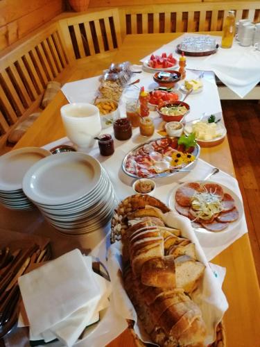 a table with plates of food and bread on it at Tourist Farm Pri Martinovih in Krška Vas