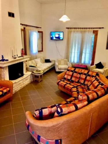 a living room with a large couch in a room at Villa Vasiliki in Palioúras