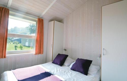 a small bedroom with a bed and a window at Strandblick 2 - Dorf 1 in Travemünde