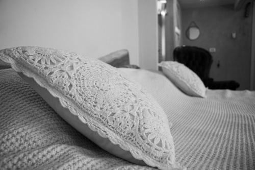 a white bed with two pillows on it at Gate Away B&B Units - המקום באל רום in El-Rom