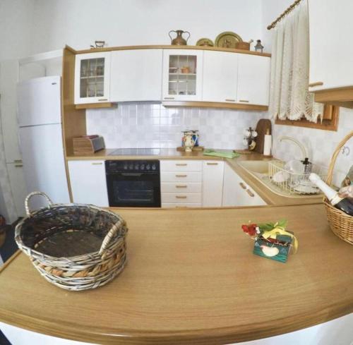 a kitchen with a table with a basket on it at Villa Vasiliki in Palioúras