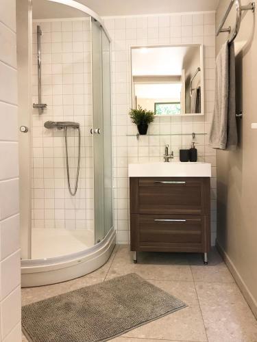 a bathroom with a shower and a sink at Namelis Palangoje in Palanga