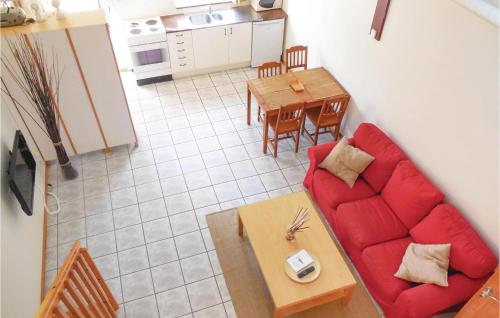 a living room with a red couch and a table at Gorgeous Apartment In Ystad With Wifi in Ystad