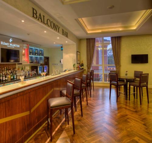 a bar in a restaurant with a table and chairs at Villa Rosa Kempinski in Nairobi