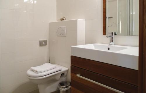 a white bathroom with a sink and a toilet at Beautiful Apartment In Lasko With Wifi in Laško