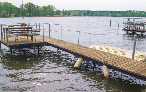 a wooden dock in the middle of a lake at Two-Bedroom Holiday Home In Neue Muhle in Neuemühle