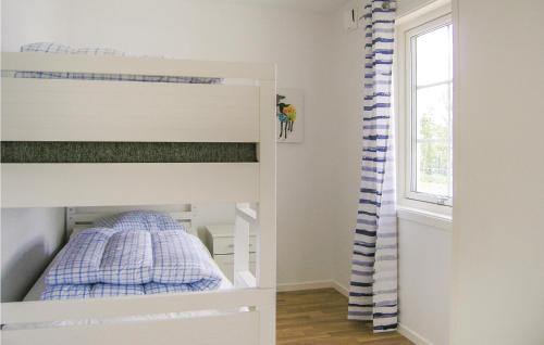 a white bunk bed in a room with a window at Amazing home in Bolms with 3 Bedrooms, Sauna and WiFi in Bolmsö