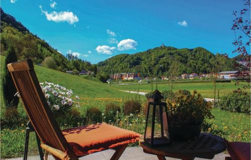 a chair and a table with a view of a hill at Beautiful Apartment In Lasko With Wifi in Laško