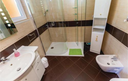 a bathroom with a shower and a sink and a toilet at Lovely Apartment In Crikvenica With Wifi in Crikvenica