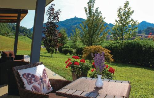 a patio table with a vase on it with flowers at Beautiful Apartment In Lasko With Wifi in Laško