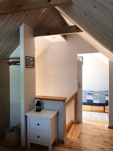 a room with a white table and a wooden floor at Namelis Palangoje in Palanga