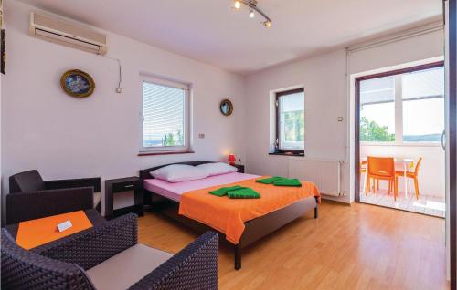 a bedroom with a bed and a table and chairs at Lovely Apartment In Crikvenica With Wifi in Crikvenica