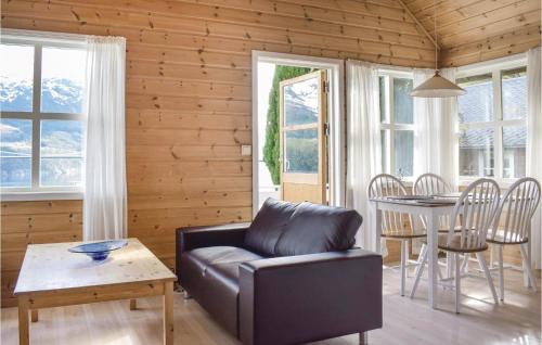 a living room with a couch and a table at Gorgeous Home In Vallavik With Wifi in Vangsbygd