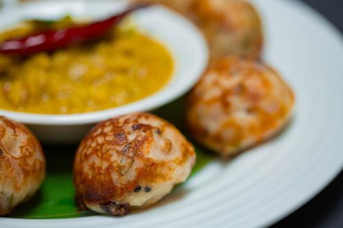 a plate of food with muffins and a bowl of soup at Maison Perumal Pondicherry - A CGH Earth Experience in Puducherry