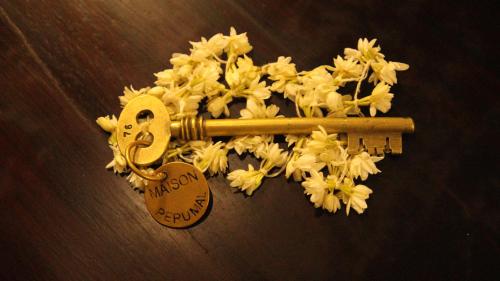 a bunch of flowers with a key and a heart at Maison Perumal Pondicherry - A CGH Earth Experience in Puducherry