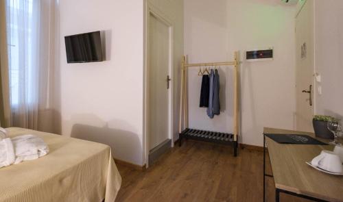 a room with a bed and a table and a door at Agora Residence in Chios