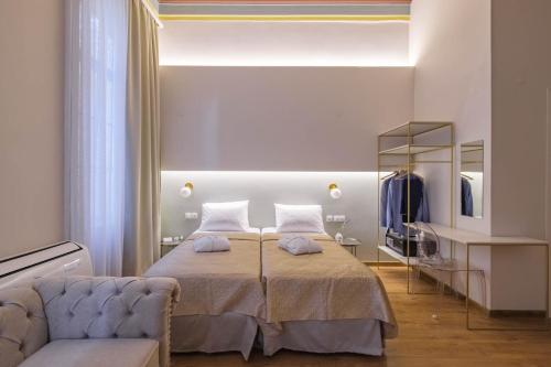 a bedroom with a bed with a chair and a mirror at Agora Residence in Chios