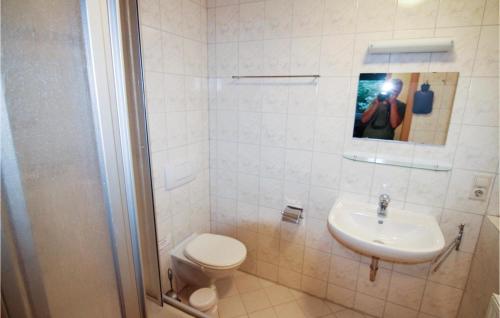 a bathroom with a toilet and a sink at Gorgeous Apartment In Crinitzberg-brenwalde With Kitchen in Bärenwalde