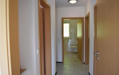 a hallway of a bathroom with a toilet and a sink at Awesome Home In Gerolstein-hinterhaus, With 3 Bedrooms And Wifi in Hinterhausen