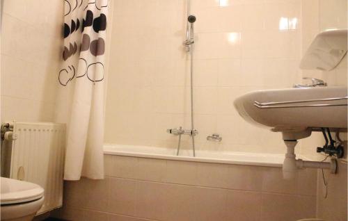 a bathroom with a sink and a bath tub at Beautiful Apartment In Breskens With 1 Bedrooms And Wifi in Breskens