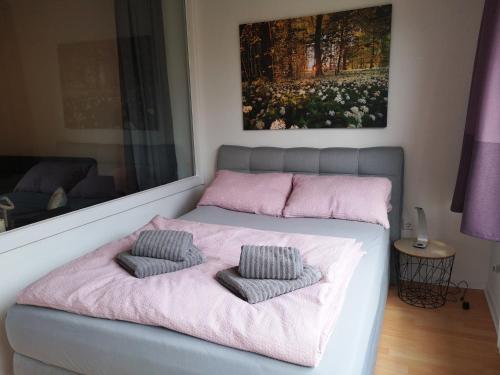 a bedroom with a bed with two pillows on it at City Apartment Bahnhofnah in Kiel