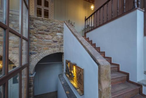 a staircase in a house with a stone wall at Agora Residence in Chios