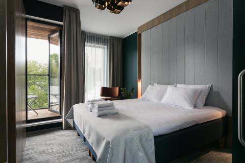 a bedroom with a bed and a window at Wasa Resort Hotel, Apartments & SPA in Pärnu