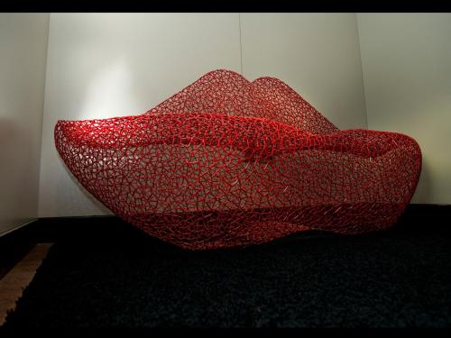 a red couch sitting next to a wall at Sure Hotel by Best Western Milano in Padova