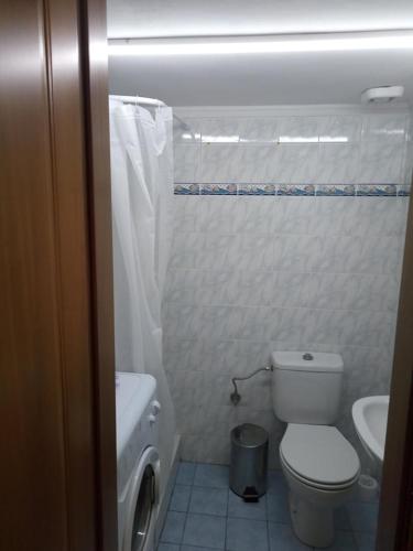 a small bathroom with a toilet and a sink at Vanessa's studio in Agia Triada
