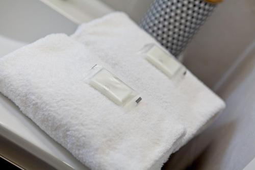 a stack of white towels sitting on a table at CASA VACANZE MARCONI 22 in Marone