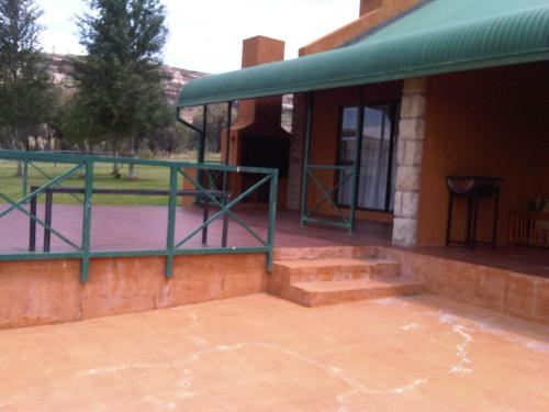 a building with stairs and a green awning at Pumula Guest Farm in Fouriesburg