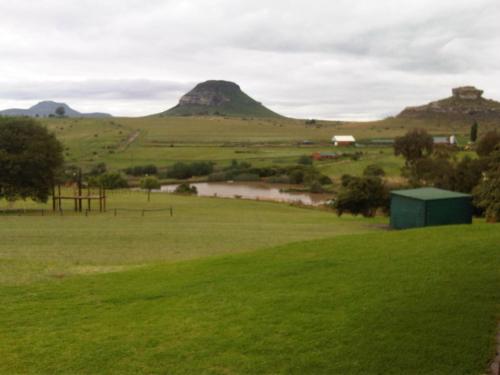 a view of a field with mountains in the background at Pumula Guest Farm in Fouriesburg