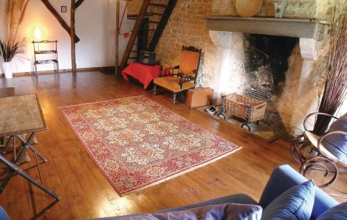 a living room with a rug and a fireplace at Holiday Home Le Coussot in Beaulieu-sur-Sonnette