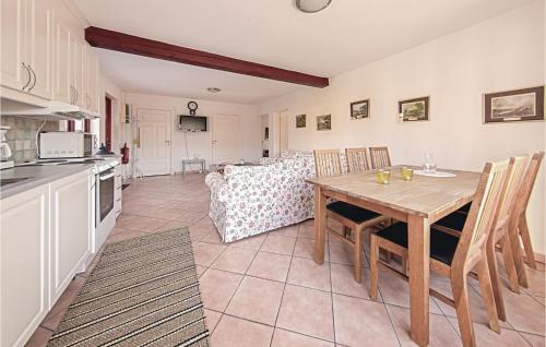 a kitchen and dining room with a table and chairs at Three-Bedroom Holiday Home In Tomelilla in Tomelilla