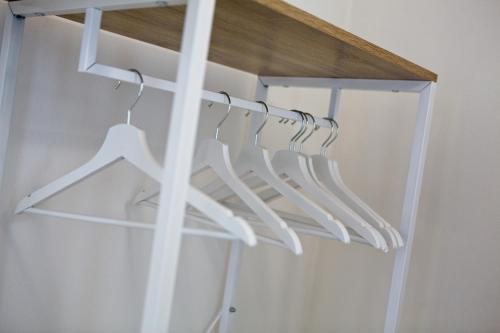 a row of white hangers in a closet at CASA VACANZE MARCONI 22 in Marone