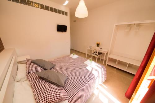 a room with a bed with two pillows on it at La Balestra B&B in Balestrate