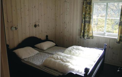 an unmade bed in a room with a window at Stunning Home In Hemsedal With 4 Bedrooms, Sauna And Wifi in Hemsedal